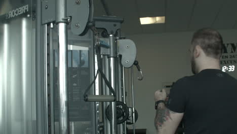 Close-Up-of-a-Man-Adding-Handles-Onto-a-Gym-Pulley-Machine