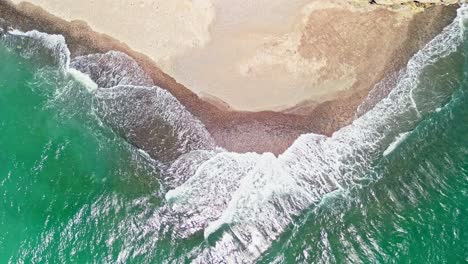Aerial-top-down-shot-of-waves-reaching-the-shore-at-Tortuga-Island,-Costa-Rica