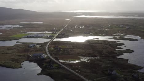 Drone-shot-of-the-main-road-through-South-Uist,-part-of-the-Outer-Hebrides-of-Scotland