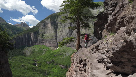 Woman-on-Via-Ferrata-Climbing-Route-Walking-in-Rocks-Above-Stunning-Green-Valley-Colorado-USA
