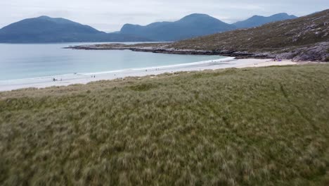 Cinematic-drone-shot-of-Luskentyre-Beach-with-the-Harris-mountains-in-the-background