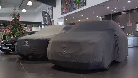 Mercedes-cars-covered-by-a-Mercedes-cover-in-a-dealership