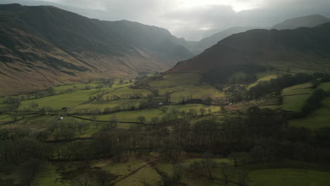 High-Altitude-view-of-green-English-valley-with-shadowy-misty-mountains-in-English-Lake-District-UK