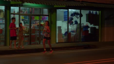 Female-jogger-athlete-during-the-nighttime-Samui-run,-Koh-Samui-Island,-Thailand