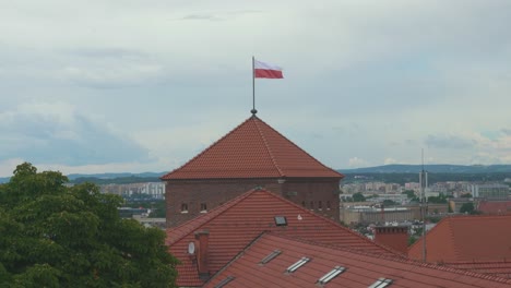 Royal-Wawel-Castle-and-Gothic-Cathedral-in-Krakow,-Poland,-With-Sandomierska-and-Senatorska-Towers,-Polish-Flag-on-the-Tower