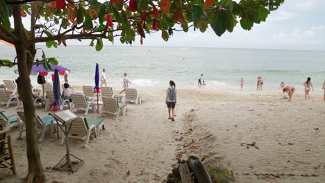 woman-walking,-entering-the-beach-of-La-Mai,-Koh-Samui-island