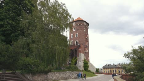 KRAKOW,-POLAND---11-JULY-2022:-Royal-Wawel-Castle-and-Gothic-Cathedral-in-Krakow,-Poland,-With-Sandomierska-and-Senatorska-Towers,-Walls,-Yard,-Park-and-Tourists