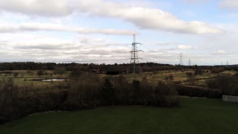 Electricity-distribution-power-pylon-overlooking-British-parkland-countryside