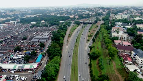 The-highway-beside-Wusa-Market-in-Abuja,-Nigeria---aerial-flyover