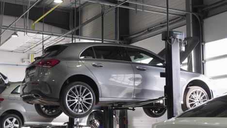 A-gray-car-on-the-lift-of-a-garage