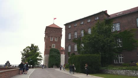 KRAKOW,-POLAND---11-JULY-2022:-Royal-Wawel-Castle-and-Gothic-Cathedral-in-Krakow,-Poland,-With-Sandomierska-and-Senatorska-Towers,-Walls,-Yard,-Park-and-Tourists