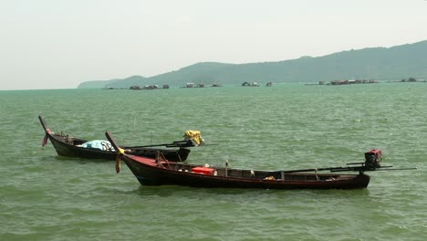 Fisherman-long-boat-at-Phuket-Thailand-dock-background-mountain
