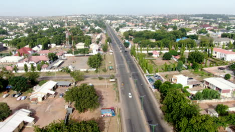 Busy-highway-in-the-west-African-city-of-Gombe,-Nigeria---ascending-aerial-view