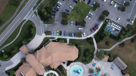 Aerial-view-above-a-parking-lot-and-pool-area-at-the-Champions-Gate-resort,-in-Orlando,-Florida,-USA---top-down,-drone-shot