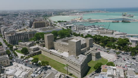 Aerial-footage-during-the-day-rotating-around-the-Castello-Svevo-di-Bari-in-Bari,-Italy