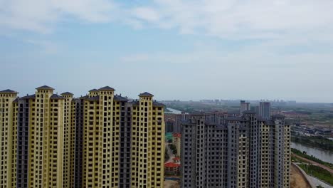 Cinematic-aerial-establishing-shot-of-empty-tall-skyscrapers-in-China,-Nanhai-New-District