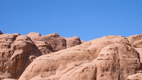 Red-and-rugged-mountainous-desert-landscape-of-remote-Wadi-Rum-wilderness-in-Jordan,-Middle-East