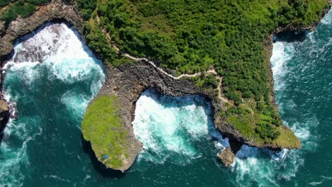Secluded-path-on-cliffs,-Kesirat-beach-diverse-shoreline,-Indonesia,-aerial-view