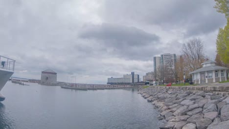 Timelapse-from-a-low-waterfront-view-of-an-empty-harbour-with-storm-clouds