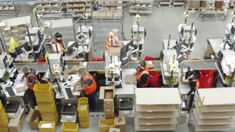 Aerial-Shot-Of-Warehouse-Workers-Distributing-Shipping-Parcels-For-Courier-Industry