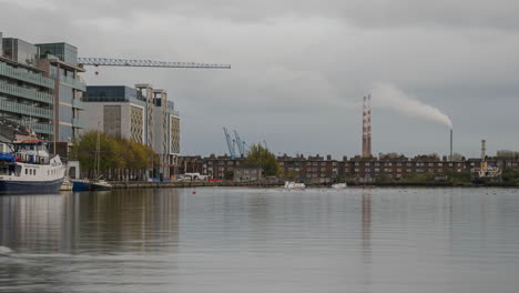 Time-lapse-of-Liffey-river-with-residential-and-industrial-area-in-the-background-during-the-day-in-Dublin-city-in-Ireland