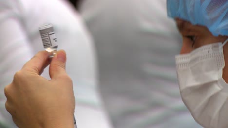 Nurse-fill-a-syringe-with-one-dose-of-the-COVID-vaccine---isolated