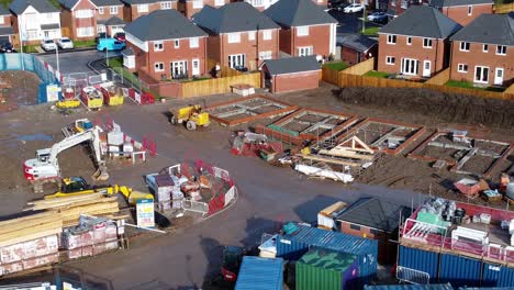 Construction-site-aerial-view-above-new-urban-real-estate-housing-development-regeneration-close-descending-tilt-up