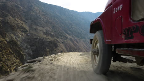 Jeep-Rojo-4x4-Conduciendo-Por-Empinadas-Pistas-De-Montaña-De-La-Carretera-De-Los-Prados-De-Hadas-En-Gilgit-baltistán,-Pakistán