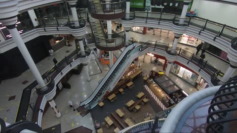 Peering-Over-Railing-Inside-Shopping-Centre-During-Lockdown-In-London