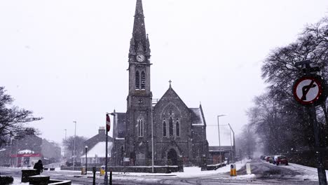 A-man-walks-past-Mannofield-church-in-a-snowstorm
