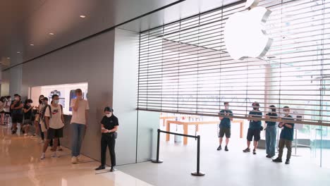 Shoppers-queue-in-line-outside-the-Apple-store-as-employees-clap-while-the-gate-is-opening-during-the-launch-day-of-the-new-iPhone-13-series-smartphones-in-Hong-Kong