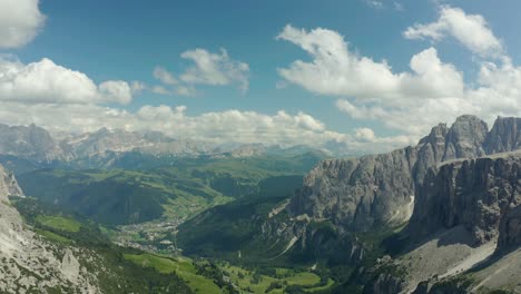 Aerial-of-green-valley-surrounded-by-dolomites-mountains-in-south-tyrol