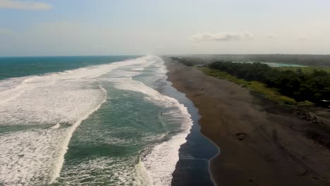 Turquoise-ocean-waves-and-remote-sandy-beach-aerial-panorama,-Java,-Indonesia