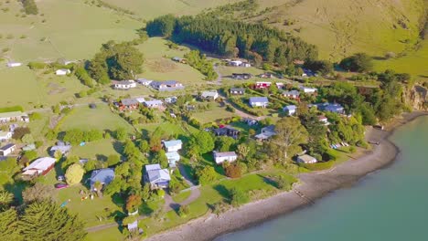 Birdseye-aerial-pull-out-view-over-Port-Levy,-once-the-largest-Maori-Settlement-in-Canterbury-New-Zealand