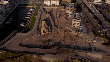 Aerial-distancing-showing-a-construction-site-of-the-new-Kade-Zuid-luxury-apartment-building-project-in-Noorderhaven-neighbourhood-in-Hanseatic-city-Zutphen,-The-Netherlands