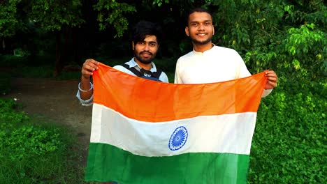 2-Indian-men-in-ethnic-clothes-holding-Indian-flags-on-national-celebration---Independence-day-of-India