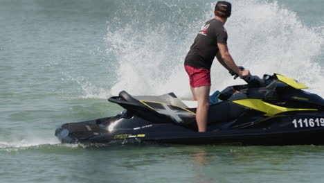 Man-flyboarding-in-slow-motion-falling-into-the-water-and-splashing