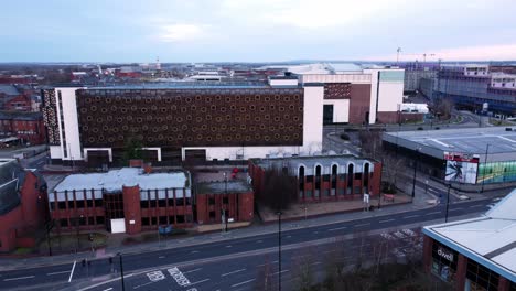 Early-morning-aerial-rising-above-Warrington-England-city-street-multi-storey-carpark-rooftop-townscape