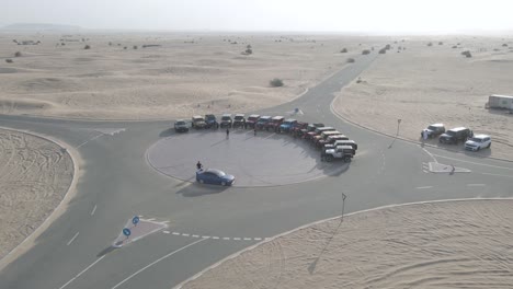 Off-road-cars-enthusiasts-meeting-on-desert-in-Dubai,-aerial