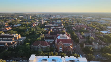 Aerial-view-overlooking-the-University-of-Florida-area,-sunset-in-USA---tracking,-drone-shot