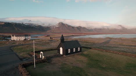 Aerial-pullout-away-from-Iceland's-famous-Black-Church-of-Budir-at-sunset
