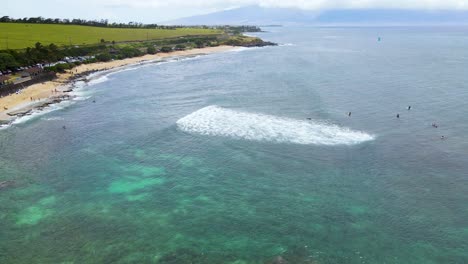 Surfers-in-the-Ocean-for-a-Swell-on-Maui-Island,-Hawaii---Aerial