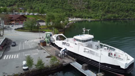 Electric-battery-powered-ferry-from-Boreal-company-going-alongside-ferry-pier-in-Kinsarvik-Hardanger-Norway---Static-aerial