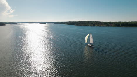 Drone-flying-over-majestic-sail-boat-in-the-Swedish-archipelago-on-summer-day