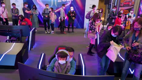 Visitors-play-themed-racing-videogames-during-the-International-Motor-Expo-showcasing-thermic-and-electric-cars-and-motorcycles-in-Hong-Kong