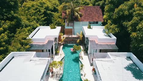 Breathtaking-aerial-drone-flight-fly-backwards-drone-shot-of-a-luxury-resort-hotel-on-a-scenic-tropical-white-sand-dream-beach-island-Gili-Trawangan-Bali-Lombok