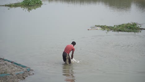 Asian-man-washing-himself-in-river,-slow-motion