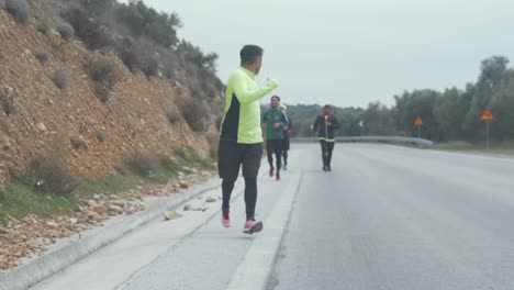 Tracking-shot-Afghan-men-running-along-road-slow-motion