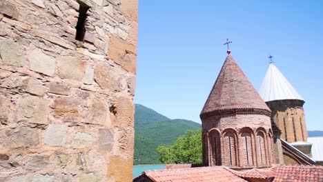 Pan-Right-Across-Old-Brickwork-Of-Ananuri-Church-Building-Overlooking-Zhinvali-Reservoir-In-Georgia