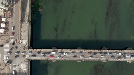 Traffic-jam-and-bridge-over-river-Po-in-city-of-Turin,-Italy,-aerial-top-down-view